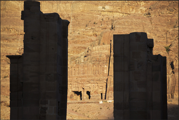 Some Tombs of the Kings seen through the columns of the Roman Gate of Trajan