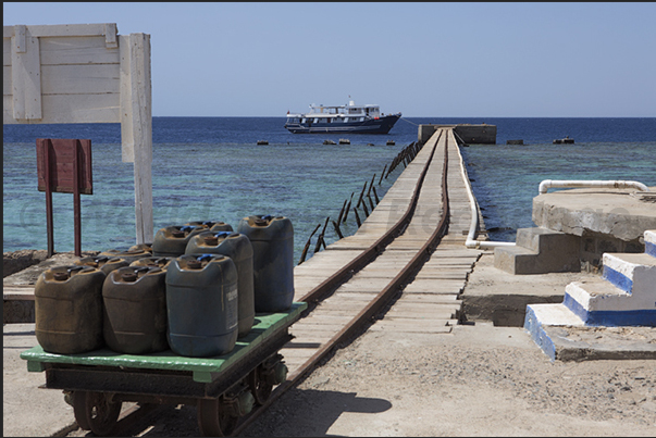 The south jetty of Sanganeb lighthouse with the cart on railway to bring the supplies of water and food to the lighthouse keepers The south jetty of Sanganeb lighthouse with the cart on railway to bring the supplies of water and food to the lighthouse keepers