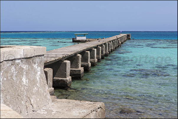 The north jetty of the lighthouse that connects the island with the large lagoon formed by the coral reef of Sanganeb The north jetty of the lighthouse that connects the island with the large lagoon formed by the coral reef of Sanganeb