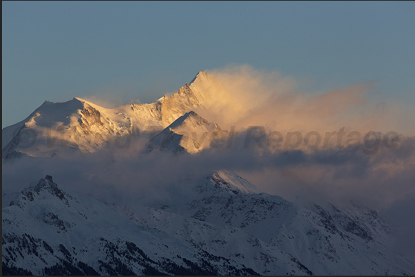 The tip of Mount Weisshorn in the valley in front of Crans-Montana The tip of Mount Weisshorn in the valley in front of Crans-Montana
