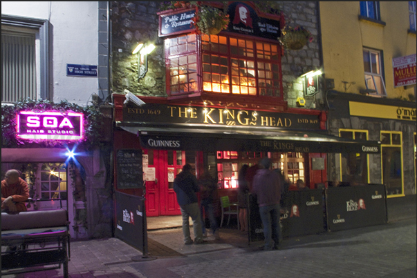 In the evening, the streets of Galway crowd of tourists in search of a pub to drink a beer and listen Irish music In the evening, the streets of Galway crowd of tourists in search of a pub to drink a beer and listen Irish music