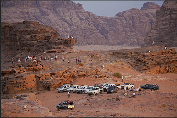 Tourists waiting the sunset in the desert mountains, one of the beautiful moments of the visit to Wadi Rum Tourists waiting the sunset in the desert mountains, one of the beautiful moments of the visit to Wadi Rum