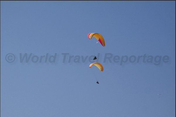 Paraglider flying over the lake Paraglider flying over the lake
