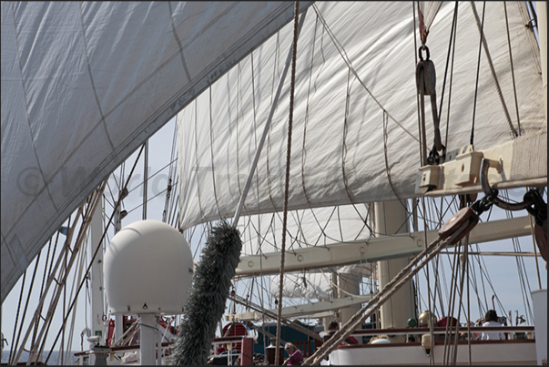 On the bridge deck, the captain teaches the passengers on the name of the sails and the concepts of navigation On the bridge deck, the captain teaches the passengers on the name of the sails and the concepts of navigation