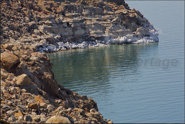 The cliffs of Dead Sea, are covered with a thick layer of salt due to the strong evaporation of the water The cliffs of Dead Sea, are covered with a thick layer of salt due to the strong evaporation of the water