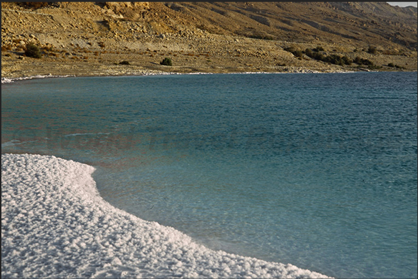 The cliffs of Dead Sea, are covered with a thick layer of salt due to the strong evaporation of the water The cliffs of Dead Sea, are covered with a thick layer of salt due to the strong evaporation of the water