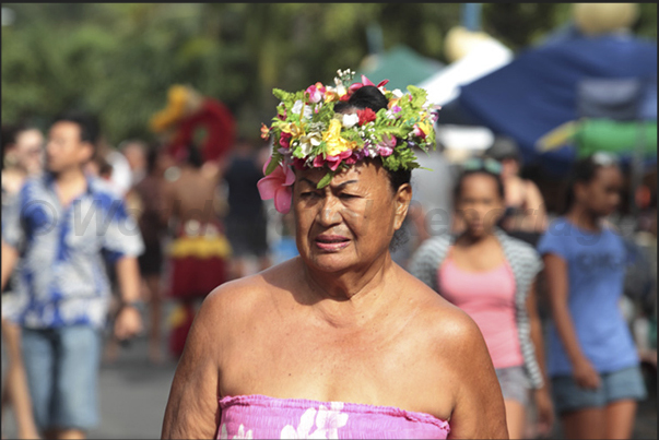 Walking through the Punanga Nui market, you can see many women wearing colorful hats made with flowers Walking through the Punanga Nui market, you can see many women wearing colorful hats made with flowers