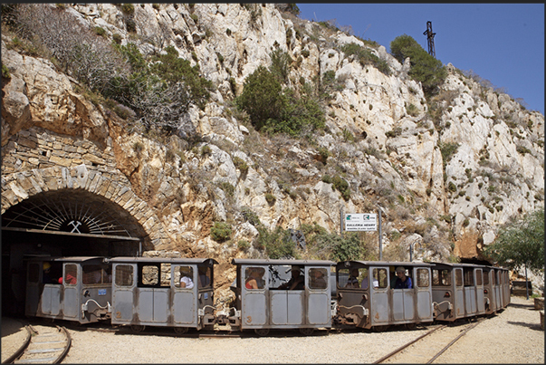 Train mine of Henry Gallery near Buggerru. The train that once pulls carts full of ore out in the mine, now pulls carts full of tourists Train mine of Henry Gallery near Buggerru. The train that once pulls carts full of ore out in the mine, now pulls carts full of tourists
