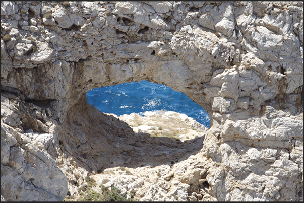 The cliff near the mining village of Buggerru. Walking on the path along the coast, is possible to see the ruins of old mines The cliff near the mining village of Buggerru. Walking on the path along the coast, is possible to see the ruins of old mines