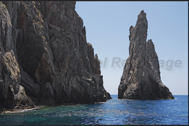 The cliff between Cala Domestica Bay and the old mine on the sea of Porto Flavia The cliff between Cala Domestica Bay and the old mine on the sea of Porto Flavia