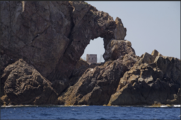The ancient Spanish watchtower (eighteenth century) at the entrance to Cala Domestica Bay The ancient Spanish watchtower (eighteenth century) at the entrance to Cala Domestica Bay