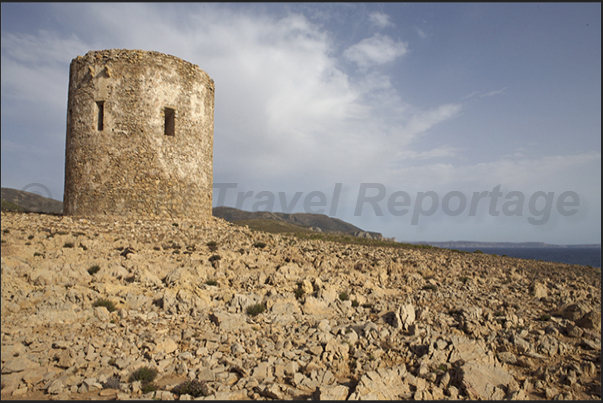 The ancient Spanish watchtower (eighteenth century) at the entrance to Cala Domestica Bay The ancient Spanish watchtower (eighteenth century) at the entrance to Cala Domestica Bay