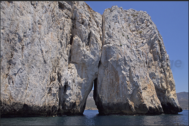One of the two large cracks in the rock of the island called Pan di Zucchero (Sugarloaf), in the Masua bay, in front of Porto Flavia One of the two large cracks in the rock of the island called Pan di Zucchero (Sugarloaf), in the Masua bay, in front of Porto Flavia