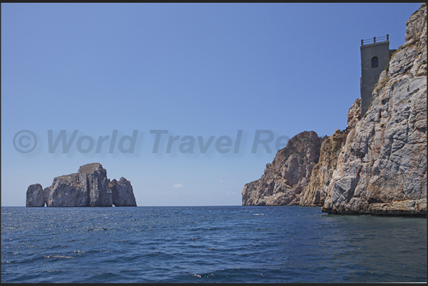 Masua Bay. The mines of Porto Flavia and, in front, the island called Pan di Zucchero (Sugarloaf)