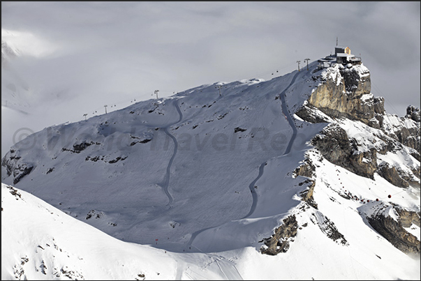 Mount Birg, the intermediate station to the summit of Mount Schilthorn and behind, the valley of Murren covered of clouds