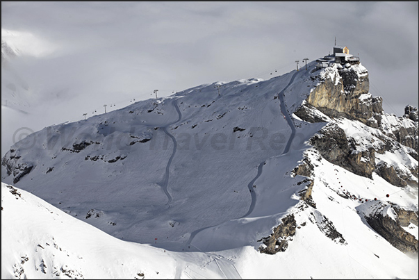 Mount Birg, the intermediate station to the summit of Mount Schilthorn and behind, the valley of Murren covered of clouds Mount Birg, the intermediate station to the summit of Mount Schilthorn and behind, the valley of Murren covered of clouds