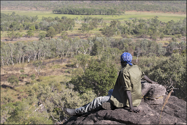 Gumbalanya, boundary of Kakadu N.P. and Arnhem Land Reserve. The guide observes the panorama from Injalak Hill Gumbalanya, boundary of Kakadu N.P. and Arnhem Land Reserve. The guide observes the panorama from Injalak Hill