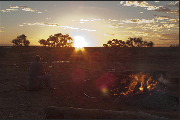 The sun sets on the outback while someone prepare dinner The sun sets on the outback while someone prepare dinner