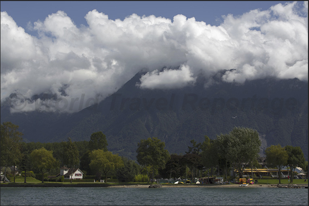 The mouth of the river Rhone in Le Bouveret and back, the French Alps hidden by low clouds over the lake The mouth of the river Rhone in Le Bouveret and back, the French Alps hidden by low clouds over the lake