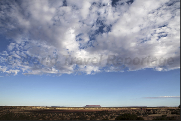 Traveling on the National 4, on the horizon you see Mount Conner often mistaken as Uluru