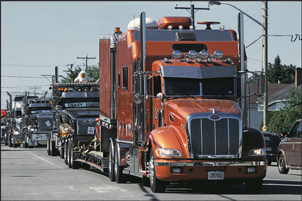 The parade of over 500 trucks through the streets of the country before starting the beauty contest and the race uphill The parade of over 500 trucks through the streets of the country before starting the beauty contest and the race uphill