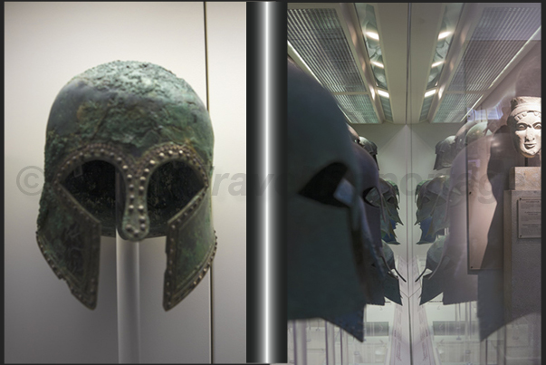 Archaeological Museum of Olympia. Ancient helmets on display in the hall of the bronzes Archaeological Museum of Olympia. Ancient helmets on display in the hall of the bronzes