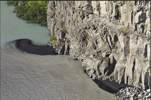 The lava of the volcanos settles in areas of calm waters creating black sand beaches The lava of the volcanos settles in areas of calm waters creating black sand beaches