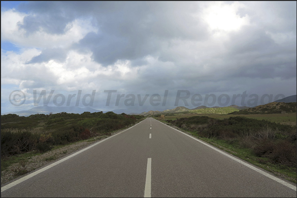 Past the mountains the road goes downwhere long straights along deserted beaches, reach the island southern tip Past the mountains the road goes downwhere long straights along deserted beaches, reach the island southern tip