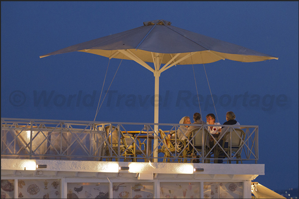 Dinner with friends on the terrace of the restaurant Dinner with friends on the terrace of the restaurant