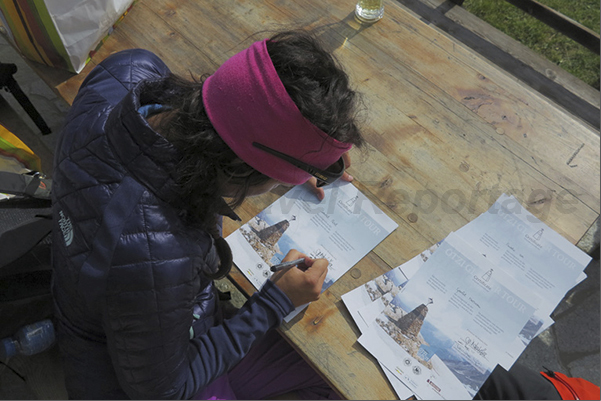 Maso Tisa, the arrival of Ötzi path. The guide Tamara Lunger, signing the certificates of those who have walked the path of Ötzi Maso Tisa, the arrival of Ötzi path. The guide Tamara Lunger, signing the certificates of those who have walked the path of Ötzi