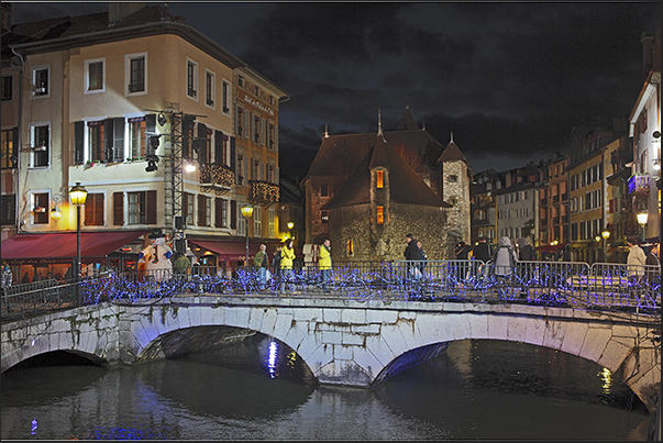 In the evening, during the Christmas season, the medieval town of Annecy is illuminated with lights and colors In the evening, during the Christmas season, the medieval town of Annecy is illuminated with lights and colors