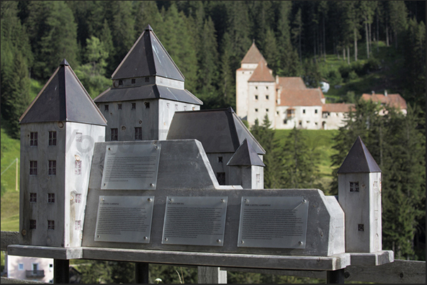 Wooden model in front of the true Gardena castle located in the other side of the valley near Santa Cristina town