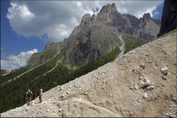 Walk on the path that leads to the base of Mount Sassolungo