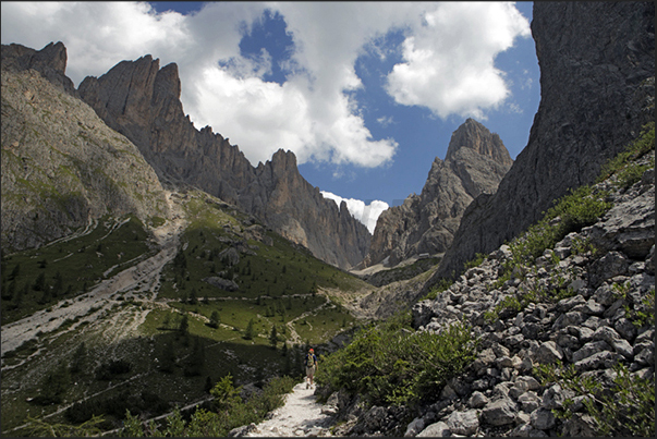 Walk on the path that leads to the base of Mount Sassolungo