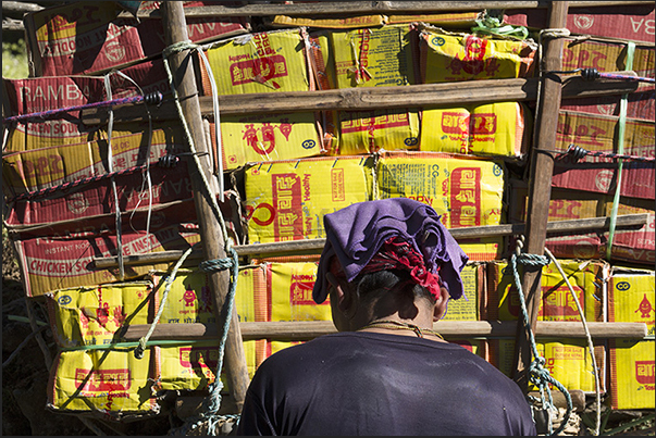 A bearer is preparing to load on his shoulders the load of goods for sale at the village of Namche Bazar (3440 m) A bearer is preparing to load on his shoulders the load of goods for sale at the village of Namche Bazar (3440 m)