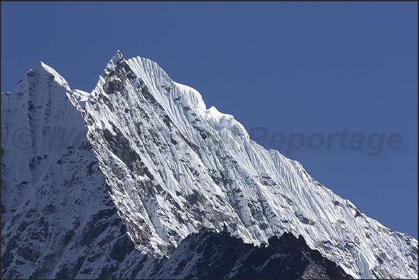 The vertical rock face of Mount Thamserku (6618 m) The vertical rock face of Mount Thamserku (6618 m)