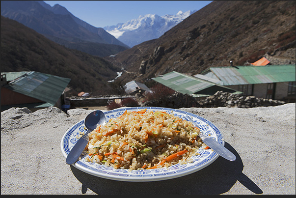 Lunch of rice and vegetables in Shomare village