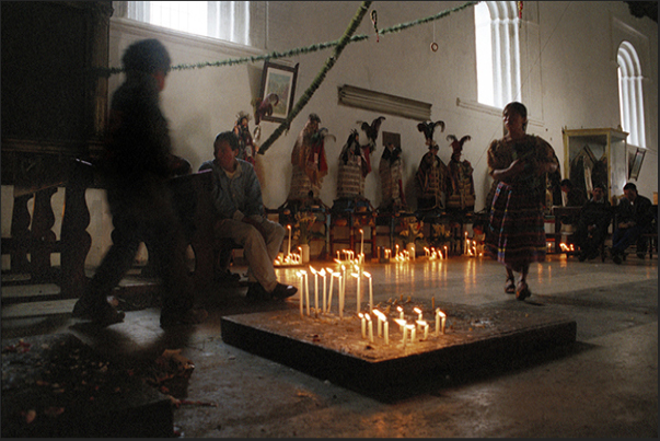 Chichigastenango. A moment of prayer in the church of St. Tomás lit by dozens of lighted candles