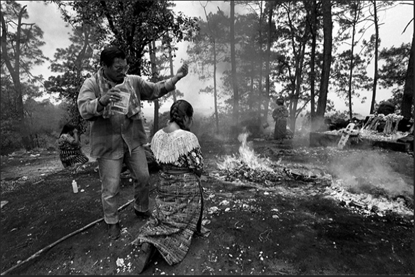 Pascual Abaj, surroundings of Chichicastenango: performing a sacred rite with shedding of aguardiente, the distillate of sugar cane