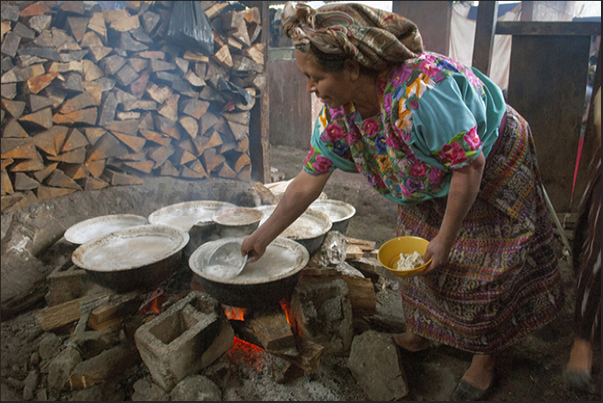 San Mateo Ixtatan, an woman prepares the black salt. Evaporation of salt water heating it and then, add the corn ground and dry all