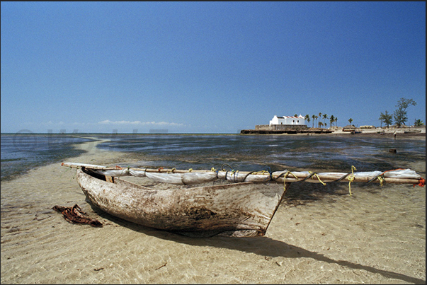 Fisherman pirogue on the beach near the church of San Antonio