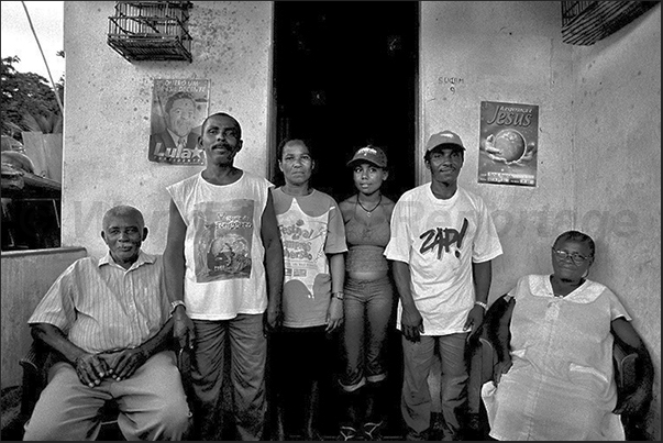 Outside the front door, gathered three generations of laborers Outside the front door, gathered three generations of laborers