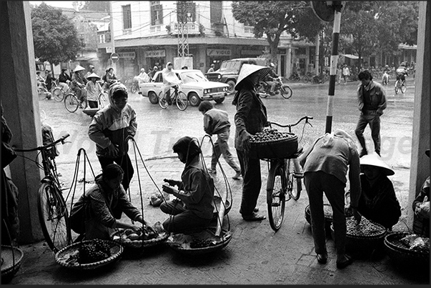 Hanoi. Market along the street under the rain Hanoi. Market along the street under the rain