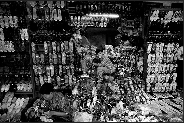 Hanoi. Neighborhood in the old part of the town. A store of sandals and shoes Hanoi. Neighborhood in the old part of the town. A store of sandals and shoes
