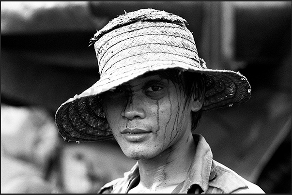 Mining village of Cam Pha. The sweat and coal dust mark the face of a young miner