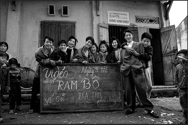 Cao Bang town. Boys in front of the cinema where is scheduled the movie â€śRamboâ€ť