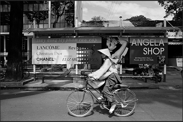 Ho Chi Minh City (Saigon). Bus stop with advertisements of western brands