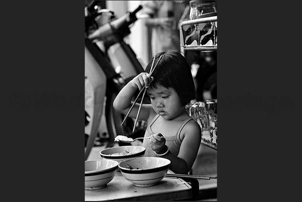Ho Chi Minh City (Saigon). First steps to learn how to sit at the table to eat Ho Chi Minh City (Saigon). First steps to learn how to sit at the table to eat