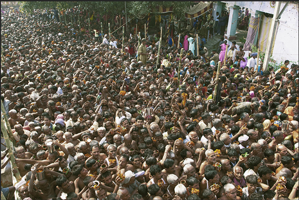 Pilgrims waiting their turn to make the offer to the Harihar Nath Tample carrying jugs with water from the holy river and flowers