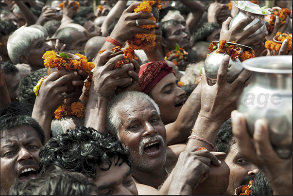 Pilgrims waiting their turn to make the offer to the Harihar Nath Tample carrying jugs with water from the holy river and flowers